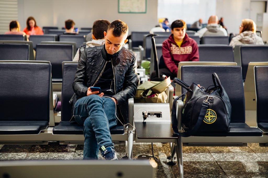Crowded gate area at a New York airport before boarding
