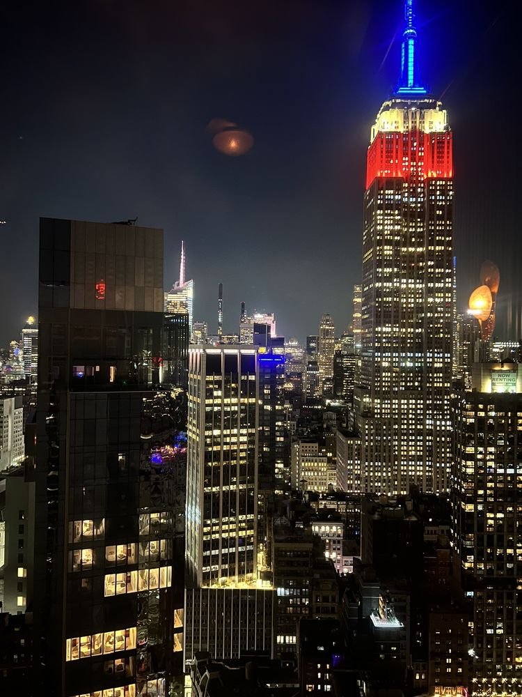 Glamorous hotel bars NYC skyline view from a Manhattan rooftop lounge at dusk