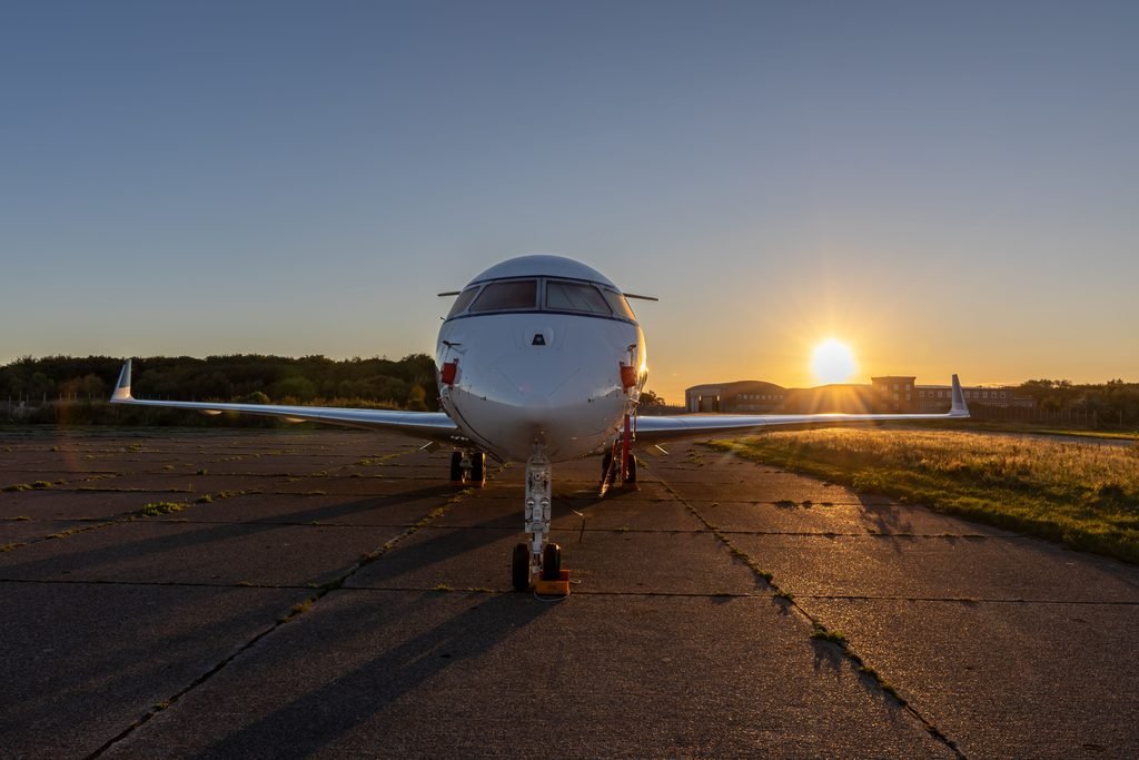 Private jet on the ramp at Teterboro Airport at sunrise with the Manhattan skyline behind it
